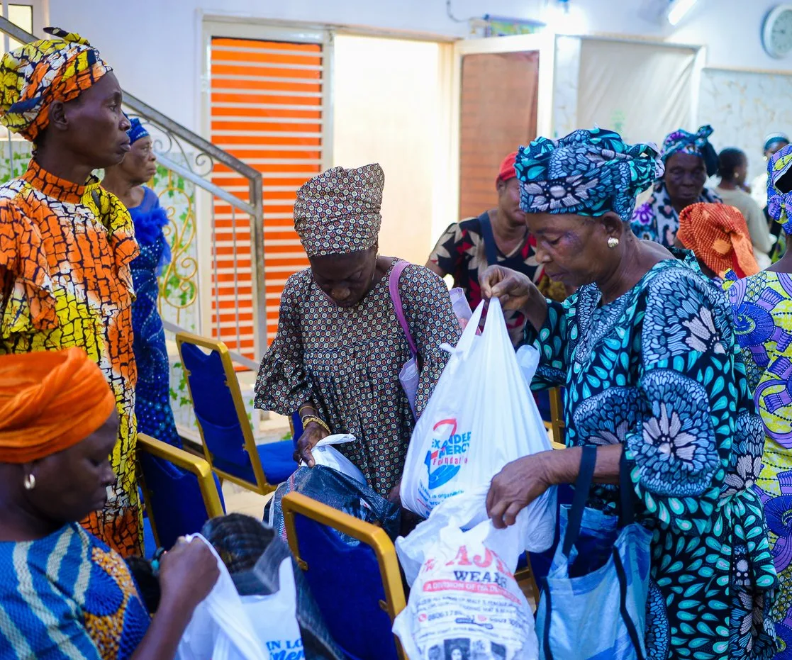 Widows look through the gifts they received at the Foundation’s outreach in Akute.