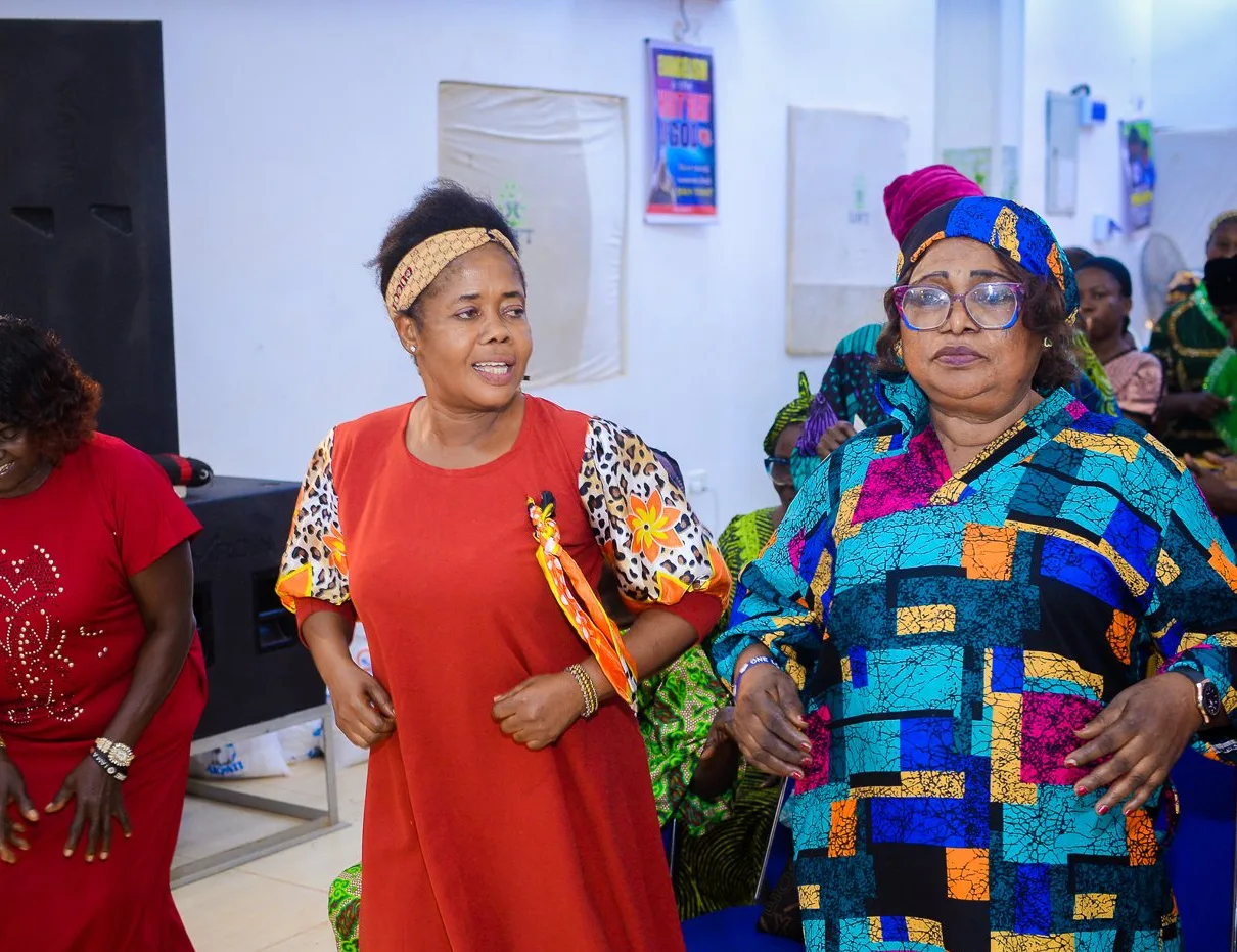 Women dance together at the Foundation’s widows’ outreach in Akute.